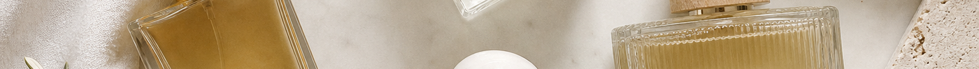 Several elegant perfume bottles arranged on a light neutral surface