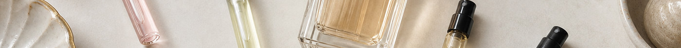 Perfume samples, a perfume bottle, and scent family cards on a light surface