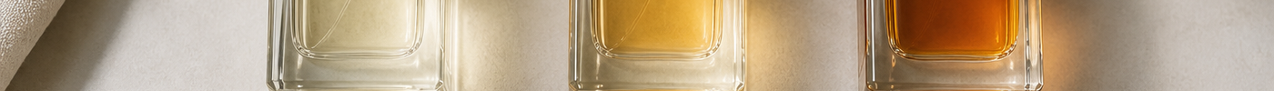 Three perfume bottles labeled Eau de Toilette, Eau de Parfum, and Parfum arranged side by side with a comparison card.